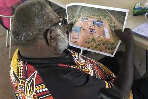 Traditional Owner looks at picture of gas field 