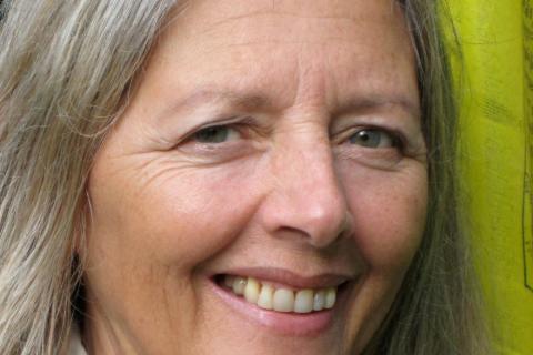 A women with silver hair and smiling blue eyes.
