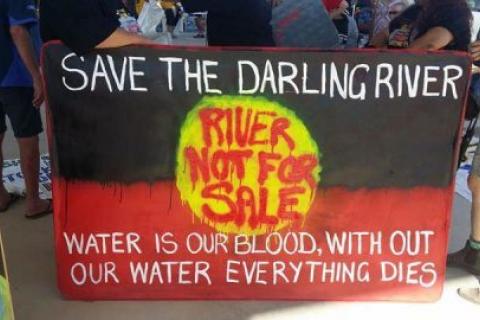 Banner of Aboriginal flag saying 'Save the Darling River; River not for sale; Water is our blood, without water everything dies'