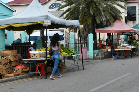 Banner image of a streetscape in Antigua, featuring a market stall.