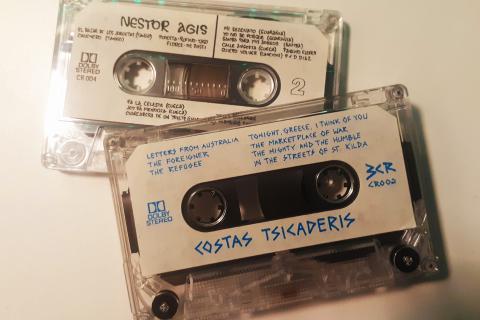 Two cassettes out of their covers. One reads "Costa Tsicaderis", and the other "Nestor Agis", along with track listings and other information.