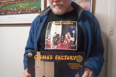 John A Tait displaying Cosmos Factory - shirt and LP