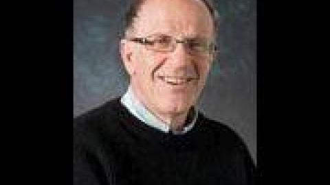 Dennis Altman grey hair glasses navy sweater