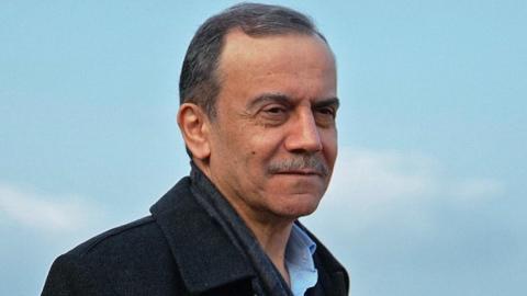 Ahmad Kaabour close-up in front of a blue sky