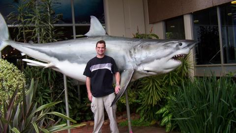The presenter with a model of a male great white shark at the entrance to the Natal Sharks Board, South Africa