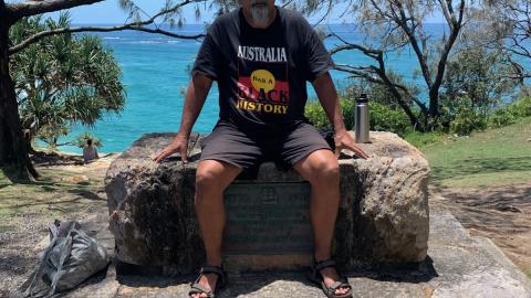 Dale Ruska sits on a monument commemorating cook.