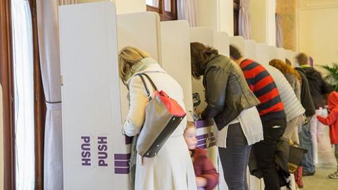 People casting their votes at an Australian federal election voting booths.