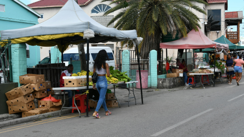 Banner image of a streetscape in Antigua, featuring a market stall.