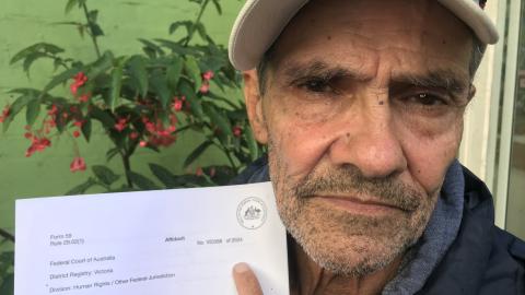 Djuran Bunjileenee Robbie Thorpe holding an affidavit in the 3CR garden