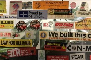 3CR kitchen window of campaign stickers about all things work and solidarity.